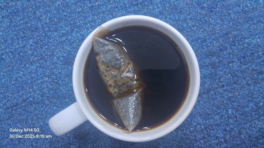 A cup of coffee with a bag in it

AI-generated content may be incorrect.